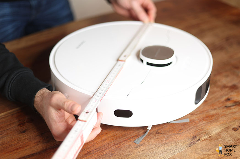 The Dreame L10s Ultra Robot Vacuum Cleaner is measured with a ruler.